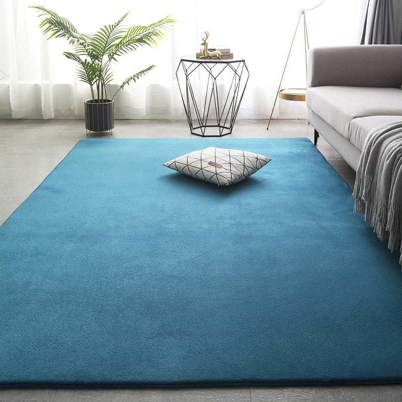 Modern minimalist coral fleece carpet in a bright living room with neutral-toned furniture and natural light

