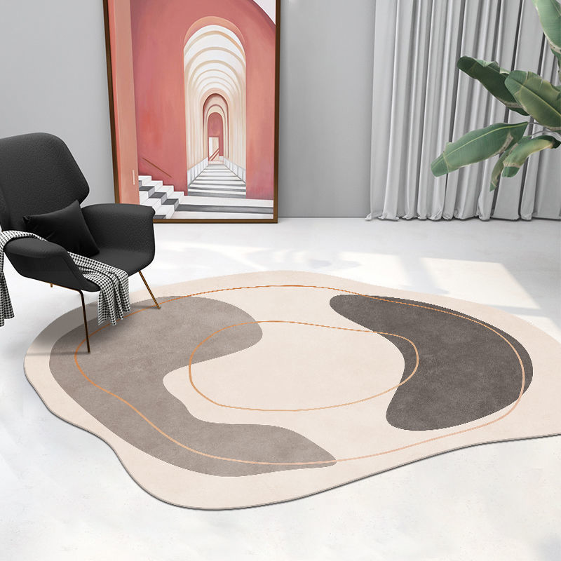 Irregular shaped carpet placed under a coffee table in a modern living room with artistic décor

