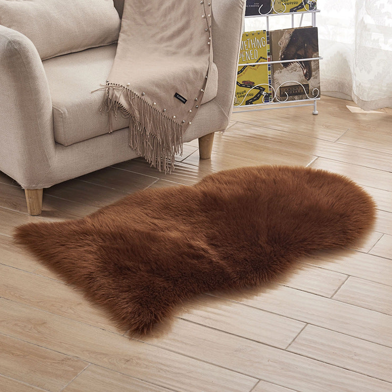Plush carpet floor mat placed in a bedroom near the bed on a wooden floor

